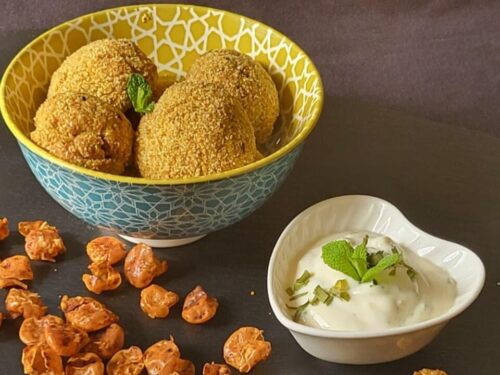 Piatto ardesia con ciotola di polpette e ciotolina di crema bianca