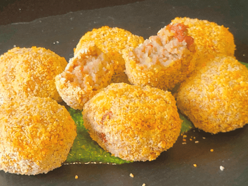 Polpette su crema verde su piatto ardesia nera