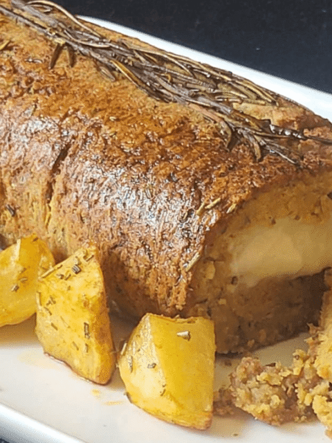 Arrosto con patate cuore filante formaggio su piatto bianco