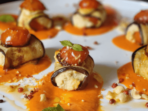 Involtini di melanzane con hummus, pomodorini su crema di peperoni, granella nocciole ,menta su piatto bianco
