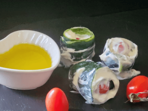 Rolls di bucce di cetrioli su piatto ardesia nera