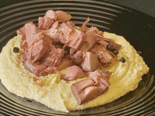 Jackfruit su hummus di ceci in piatto nero